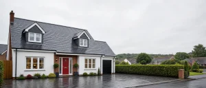 Tidy UK home with a wet pitched roof after rain
